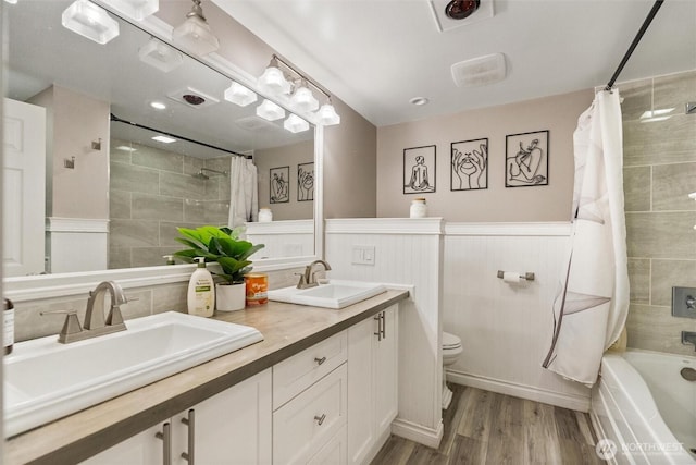 22616 88th Ave W, Edmonds, WA 98026 - bathroom with shower / bathtub combination with curtain, double vanity, wood finished floors, and wainscoting
