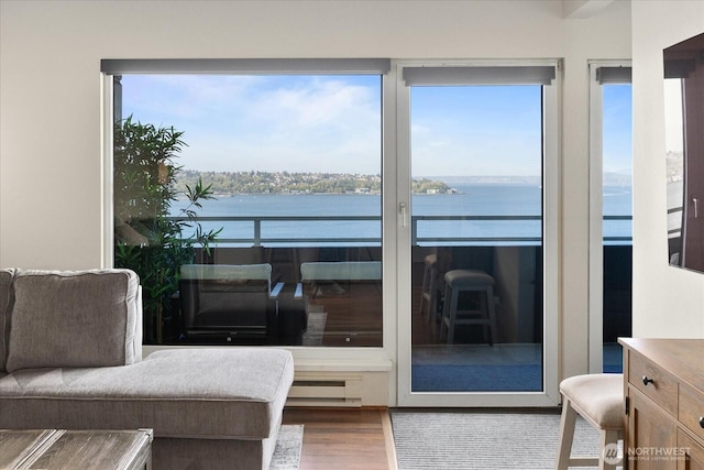 1415 2nd Ave NE Unit 1801, Seattle, WA 98101 - sunroom / solarium featuring a water view, healthy amount of natural light, and a baseboard heating unit