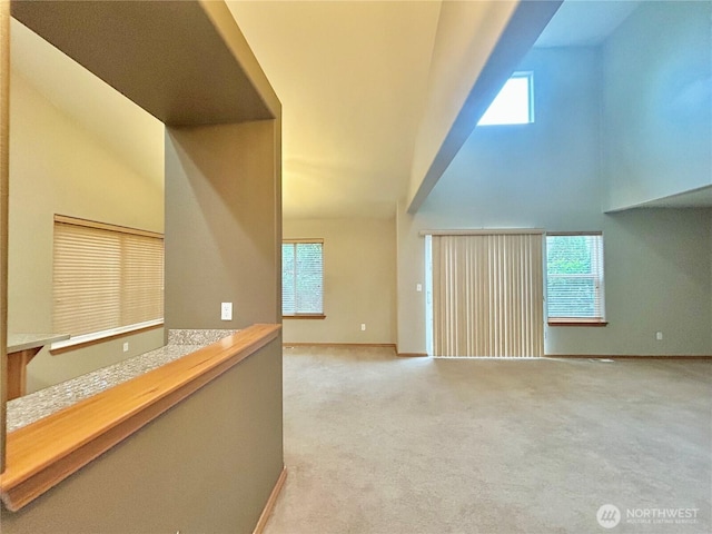4544 Durham St SE, Lacey, WA 98503 - unfurnished living room with high vaulted ceiling, plenty of natural light, and light colored carpet