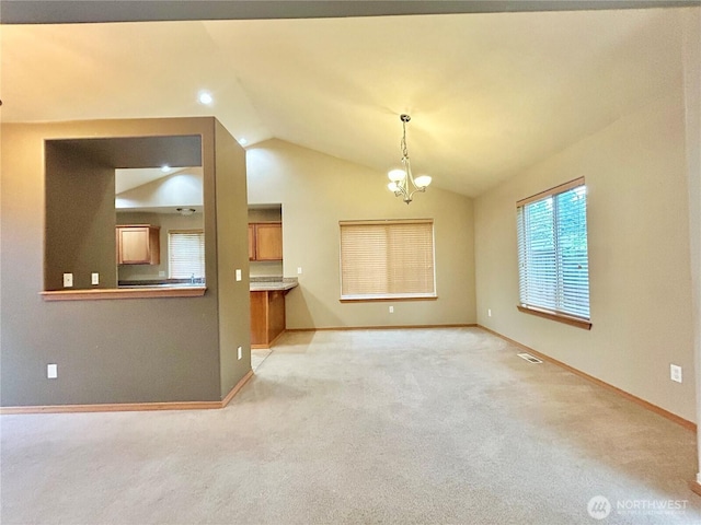 4544 Durham St SE, Lacey, WA 98503 - unfurnished living room with vaulted ceiling, light colored carpet, and a chandelier