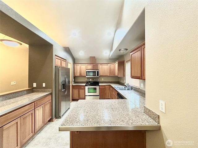 4544 Durham St SE, Lacey, WA 98503 - kitchen with stainless steel appliances, light countertops, lofted ceiling, a peninsula, and brown cabinetry