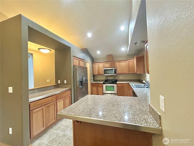 4544 Durham St SE, Lacey, WA 98503 - kitchen with stainless steel appliances, a textured wall, lofted ceiling, light tile patterned floors, and a peninsula