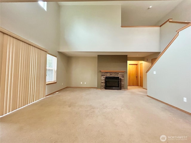 4544 Durham St SE, Lacey, WA 98503 - unfurnished living room with a high ceiling, light colored carpet, and a fireplace