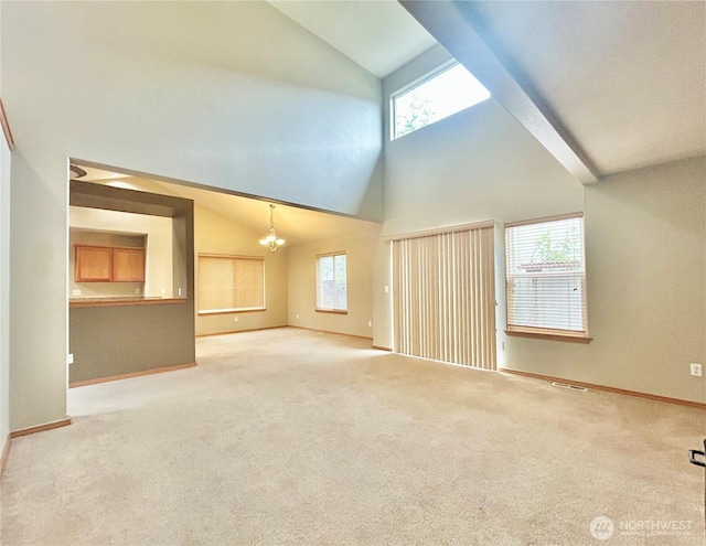 4544 Durham St SE, Lacey, WA 98503 - unfurnished living room featuring healthy amount of natural light, carpet floors, a chandelier, and high vaulted ceiling