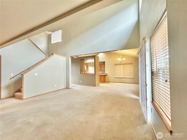 4544 Durham St SE, Lacey, WA 98503 - unfurnished living room featuring stairway, a chandelier, plenty of natural light, carpet, and a high ceiling