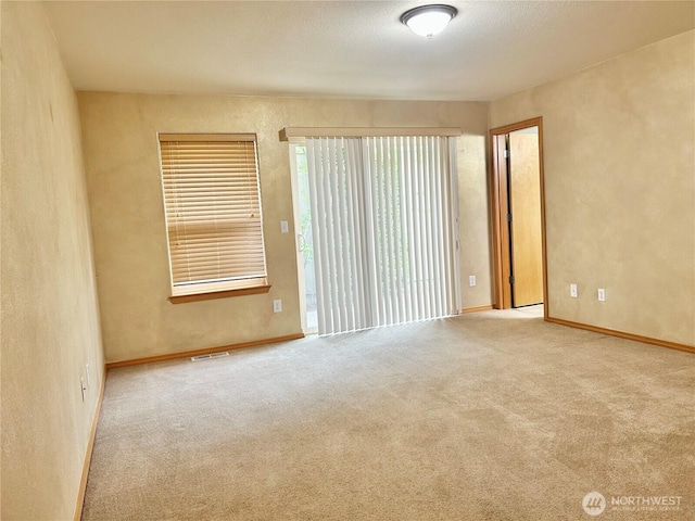 4544 Durham St SE, Lacey, WA 98503 - carpeted empty room featuring baseboards and a textured wall