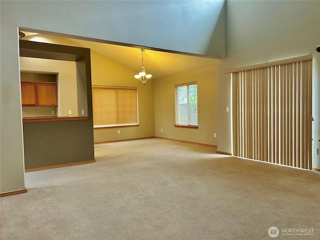 4544 Durham St SE, Lacey, WA 98503 - unfurnished living room with lofted ceiling, a chandelier, and light carpet