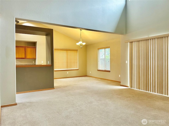 4544 Durham St SE, Lacey, WA 98503 - unfurnished living room featuring vaulted ceiling, a chandelier, and light carpet