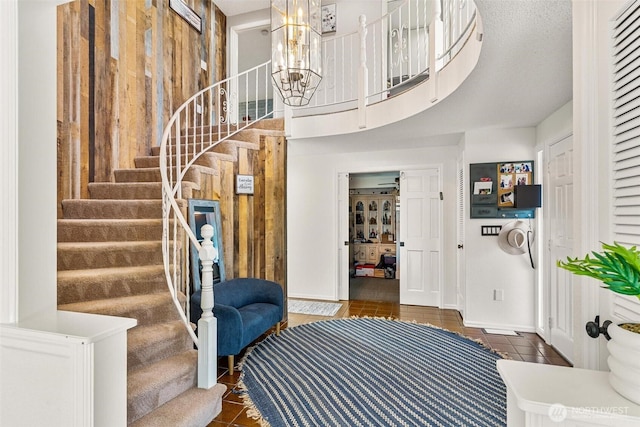 7707 42nd Ave E, Tacoma, WA 98443 - tiled entryway featuring a chandelier, stairs, and a high ceiling