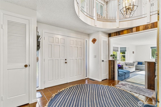 7707 42nd Ave E, Tacoma, WA 98443 - entrance foyer featuring tile patterned flooring and a chandelier
