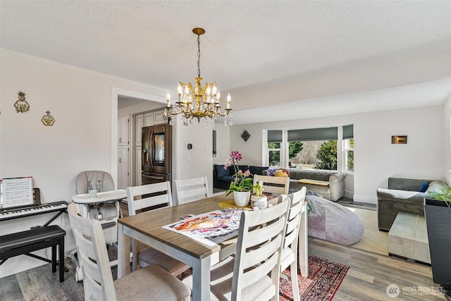 7707 42nd Ave E, Tacoma, WA 98443 - dining area with a chandelier, wood finished floors, and a textured ceiling