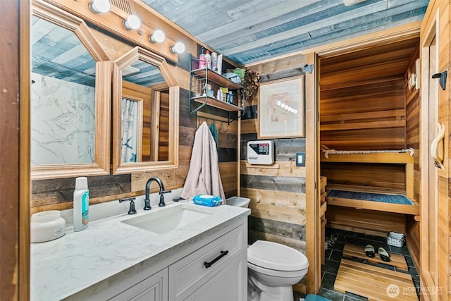 7707 42nd Ave E, Tacoma, WA 98443 - bathroom featuring vanity and wooden walls