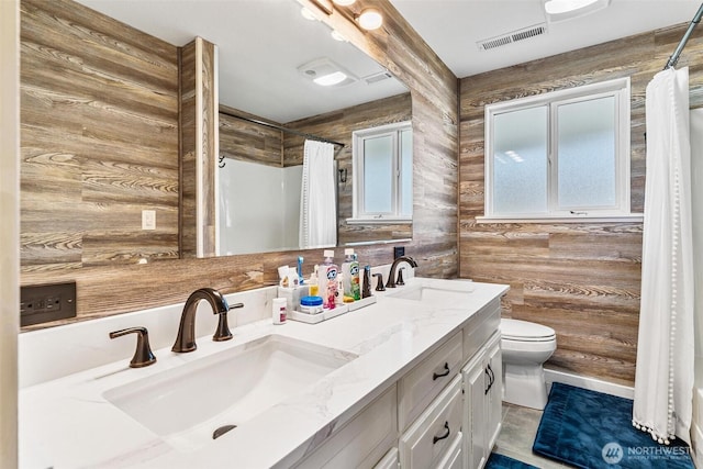 7707 42nd Ave E, Tacoma, WA 98443 - full bathroom featuring wooden walls, double vanity, and a shower with curtain