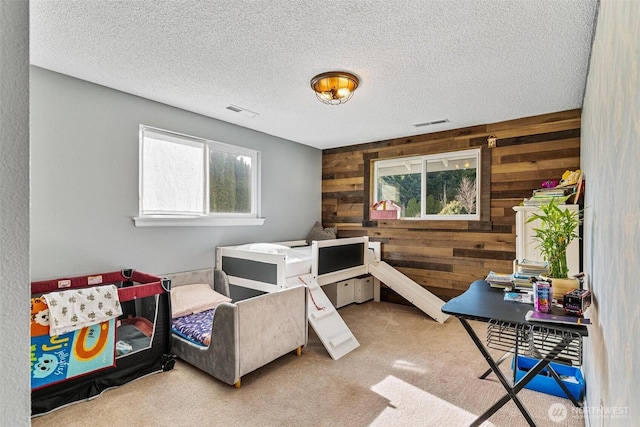 7707 42nd Ave E, Tacoma, WA 98443 - carpeted bedroom featuring wood walls and a textured ceiling