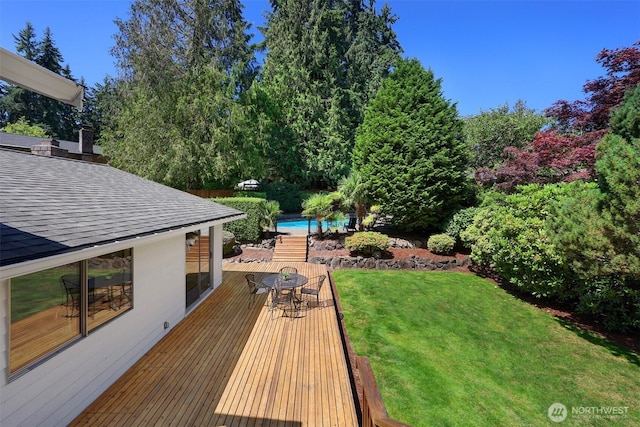207 215th St SE, Bothell, WA 98021 - wooden deck featuring outdoor dining area, a lawn, and a swimming pool