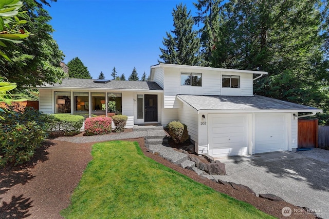 207 215th St SE, Bothell, WA 98021 - tri-level home featuring driveway, an attached garage, and a shingled roof