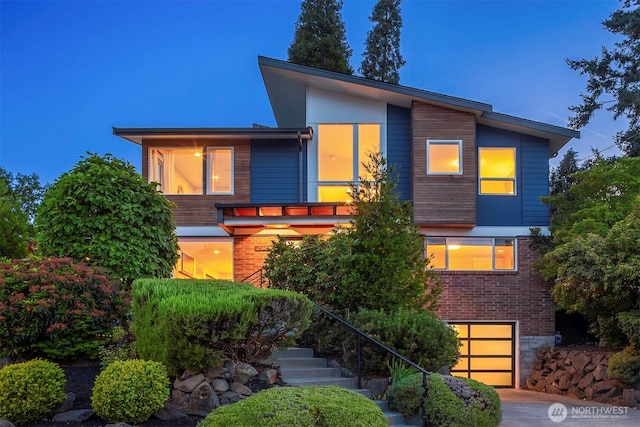 7503 32nd Ave NE, Seattle, WA 98115 - contemporary home with brick siding, a garage, and stairs