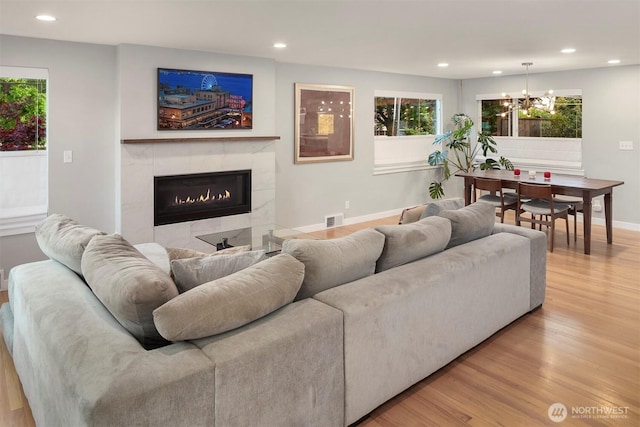 7503 32nd Ave NE, Seattle, WA 98115 - living room with light wood-style floors, a chandelier, recessed lighting, and a fireplace