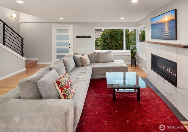 7503 32nd Ave NE, Seattle, WA 98115 - living area with wood finished floors, recessed lighting, a tile fireplace, and stairway