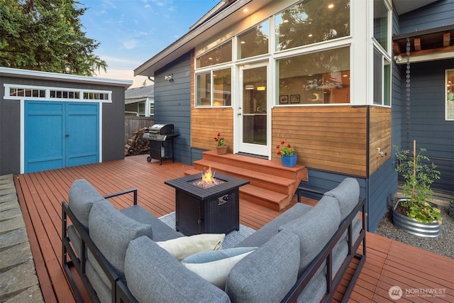 7503 32nd Ave NE, Seattle, WA 98115 - wooden deck featuring an outdoor living space with a fire pit, area for grilling, and a storage shed