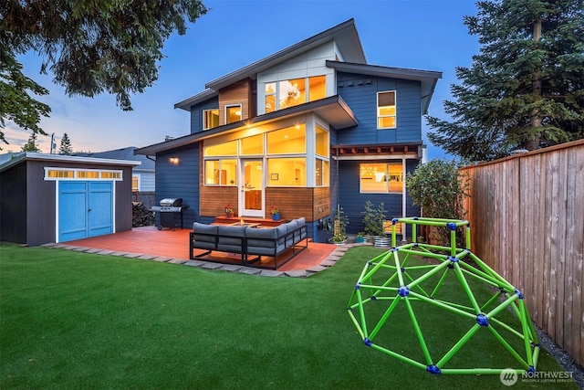 7503 32nd Ave NE, Seattle, WA 98115 - back of property at dusk featuring a storage shed and an outdoor hangout area