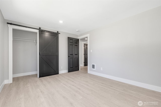 1316 115th St S, Tacoma, WA 98444 - unfurnished bedroom featuring wood finished floors, recessed lighting, a barn door, and a closet