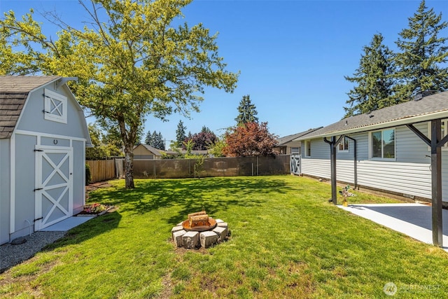 1316 115th St S, Tacoma, WA 98444 - fenced backyard with a fire pit, a storage unit, and a patio