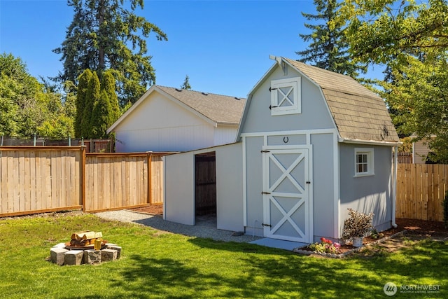 1316 115th St S, Tacoma, WA 98444 - view of shed with a fenced backyard and a fire pit
