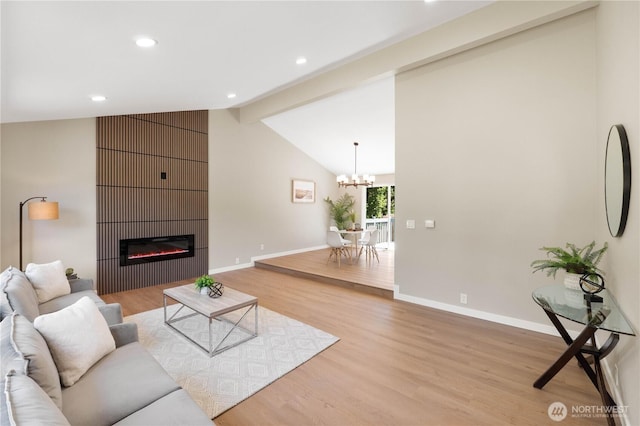 31228 47th Pl SW, Federal Way, WA 98023 - living area featuring light wood-style floors, a chandelier, a glass covered fireplace, and recessed lighting