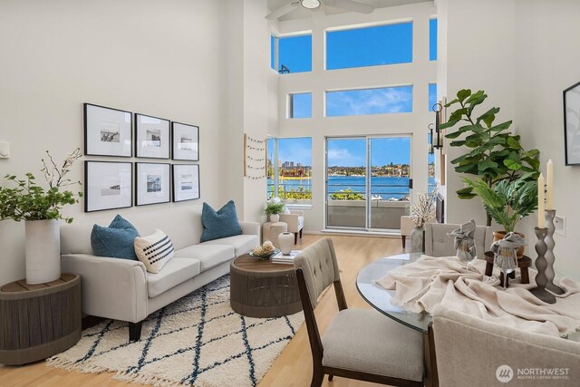 2400 8th Ave N Unit 2, Seattle, WA 98109 - living area featuring a ceiling fan, wood finished floors, a high ceiling, and a water view
