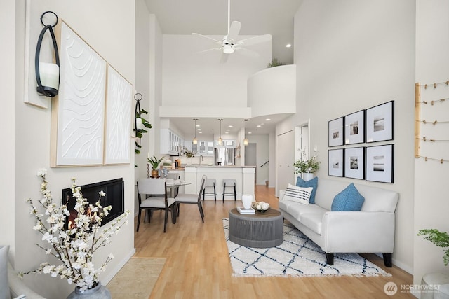 2400 8th Ave N Unit 2, Seattle, WA 98109 - living area with ceiling fan, light wood-style floors, and a towering ceiling