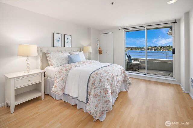 2400 8th Ave N Unit 2, Seattle, WA 98109 - bedroom featuring access to outside, light wood-style flooring, recessed lighting, and a water view