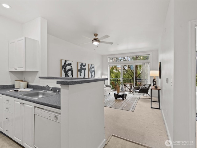 2415 2nd Ave Unit 541, Seattle, WA 98121 - kitchen with white dishwasher, dark countertops, open floor plan, white cabinetry, and ceiling fan