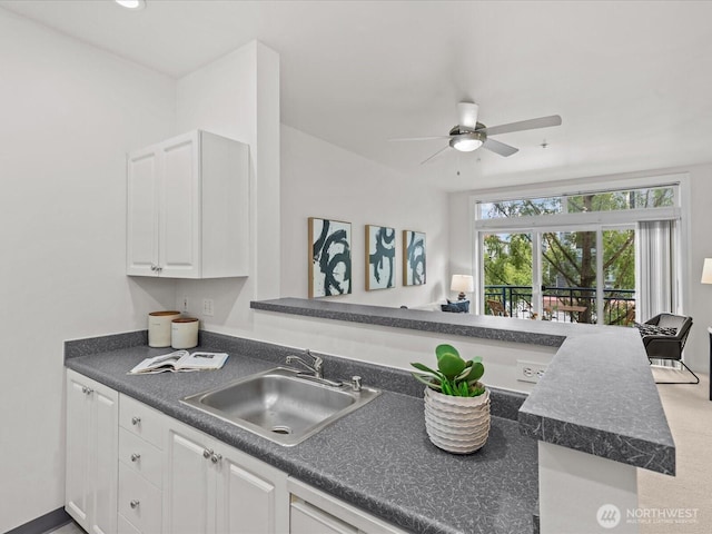 2415 2nd Ave Unit 541, Seattle, WA 98121 - kitchen featuring dark countertops, white cabinetry, and ceiling fan