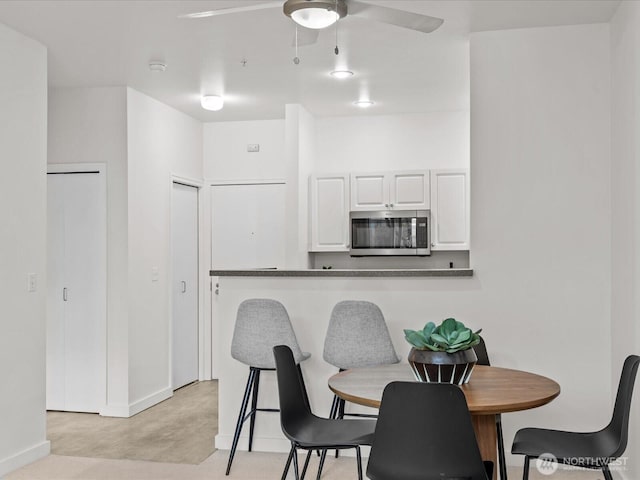 2415 2nd Ave Unit 541, Seattle, WA 98121 - dining space featuring a ceiling fan and baseboards