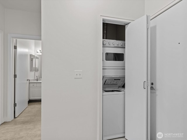 2415 2nd Ave Unit 541, Seattle, WA 98121 - washroom featuring stacked washer and clothes dryer and light wood-type flooring