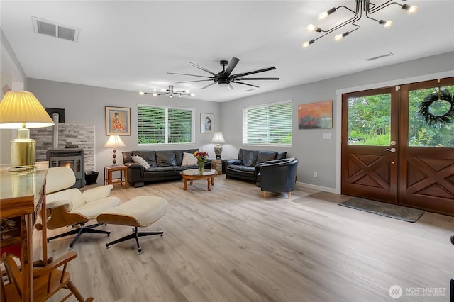 6808 243rd Ave E, Buckley, WA 98321 - living room with light wood-style flooring, a chandelier, french doors, and ceiling fan
