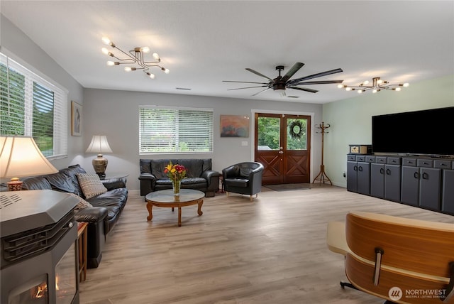 6808 243rd Ave E, Buckley, WA 98321 - living area featuring a chandelier, light wood-type flooring, and a ceiling fan
