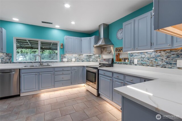 6808 243rd Ave E, Buckley, WA 98321 - kitchen featuring wall chimney exhaust hood, stainless steel appliances, backsplash, recessed lighting, and light stone countertops