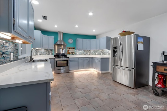 6808 243rd Ave E, Buckley, WA 98321 - kitchen with appliances with stainless steel finishes, wall chimney exhaust hood, decorative backsplash, recessed lighting, and light stone countertops