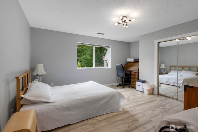 6808 243rd Ave E, Buckley, WA 98321 - bedroom featuring wood finished floors, a chandelier, a desk, and a closet