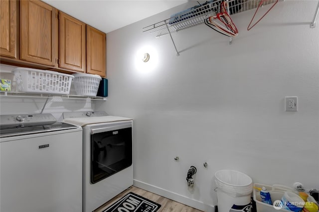 6808 243rd Ave E, Buckley, WA 98321 - laundry room with washing machine and clothes dryer, cabinet space, and light wood-type flooring