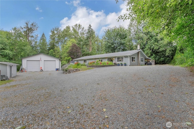 6808 243rd Ave E, Buckley, WA 98321 - ranch-style house featuring a garage, an outbuilding, a chimney, and view of scattered trees