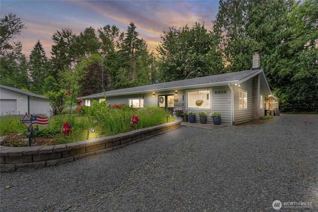 6808 243rd Ave E, Buckley, WA 98321 - view of front of house with a chimney and view of wooded area