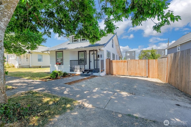 1433 E 32nd St, Tacoma, WA 98404 - bungalow featuring covered porch, asphalt driveway, and roof with shingles