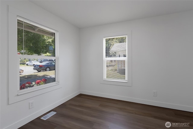 1433 E 32nd St, Tacoma, WA 98404 - empty room featuring plenty of natural light and dark wood-type flooring