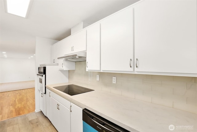 16548 115th Ave SE, Renton, WA 98055 - kitchen with black electric cooktop, white cabinetry, light countertops, and decorative backsplash