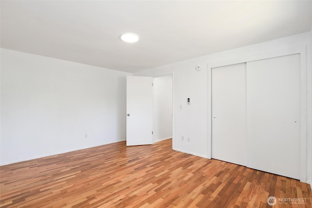 16548 115th Ave SE, Renton, WA 98055 - unfurnished bedroom featuring light wood-style flooring and a closet