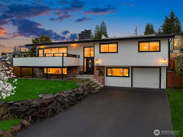 619 8th Ave S, Edmonds, WA 98020 - split foyer home with a garage, asphalt driveway, and a chimney