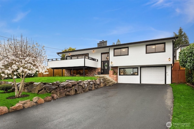 619 8th Ave S, Edmonds, WA 98020 - bi-level home featuring a garage, a chimney, asphalt driveway, and a front yard